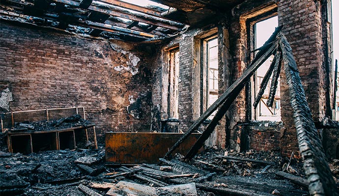 burnt room interior with walls furniture and floor structural fire damage