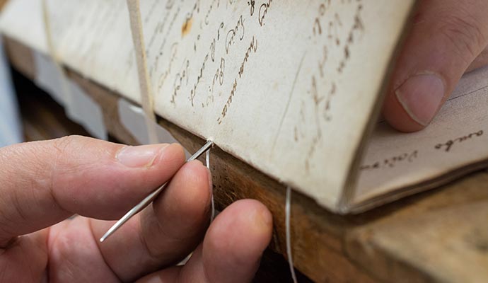 Person restoring manuscript with equipment