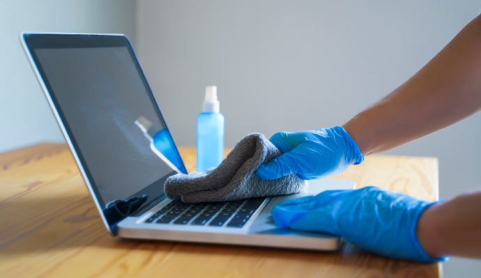 Person cleaning laptop