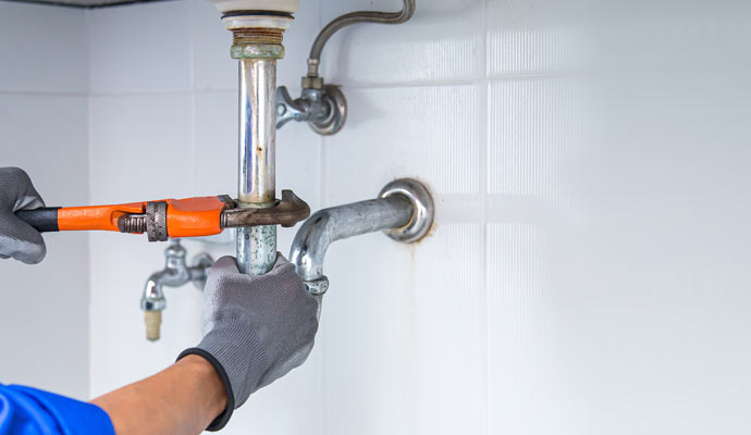 repairing water pipe under sink