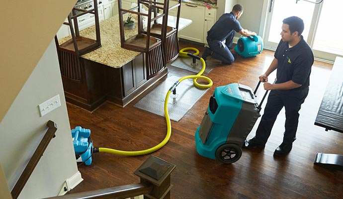 Professional water damage restoration with equipment 