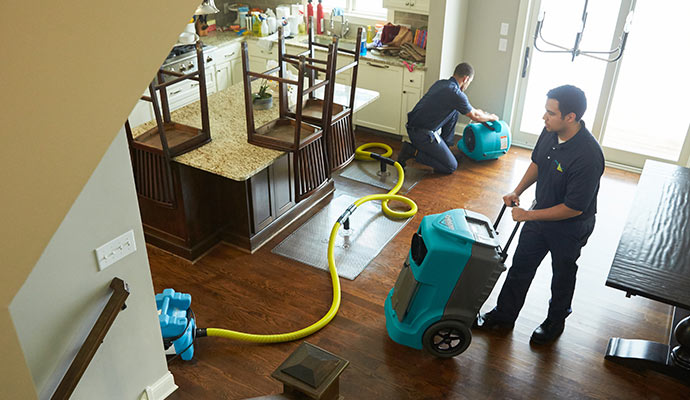 worker cleaning floor water in Annadale